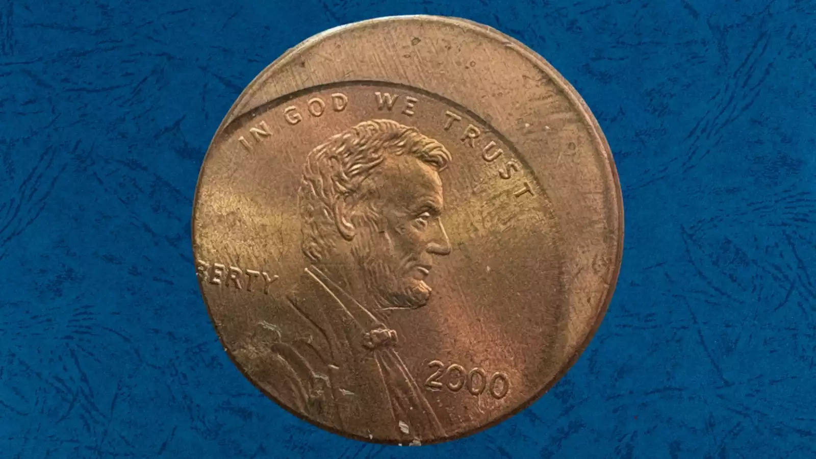 2000 penny off-center strike error showing the Lincoln cent design struck 40 to 50 percent off center with date still visible
